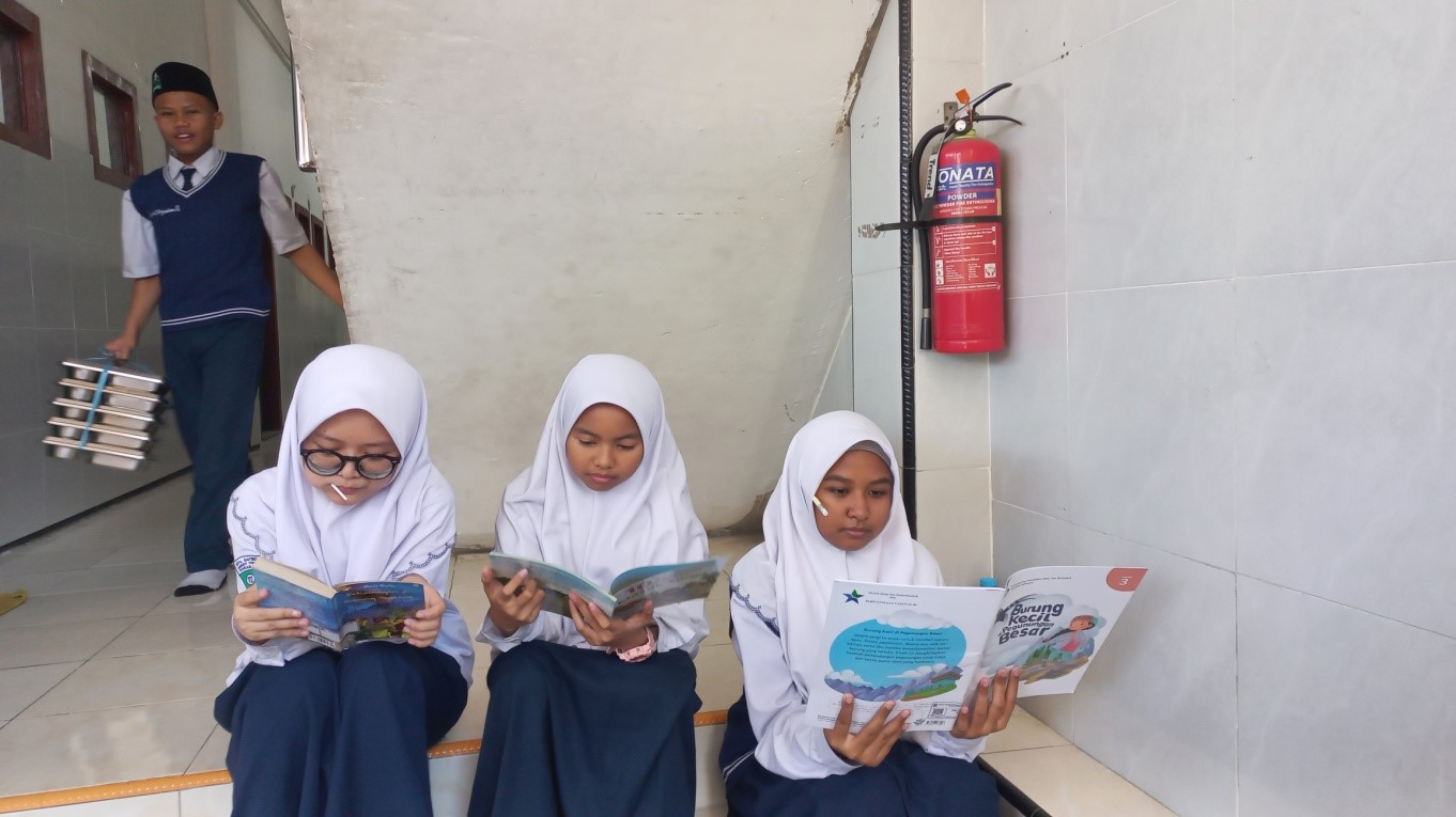 Gambar Mopus 1 Membaca di mana saja, belajar kapan saja. Murid MTs SAFINDA Surabaya memanfaatkan setiap sudut madrasah untuk menikmati buku-buku dari Mobil Perpustakaan Keliling Kota Surabaya.
